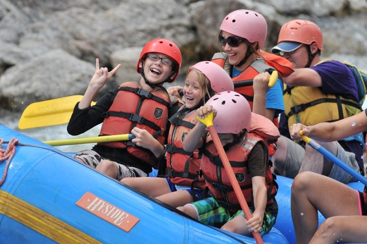 kids smiling on raft with parents
