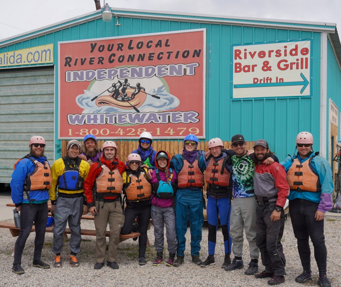 a group of people standing in front of a sign