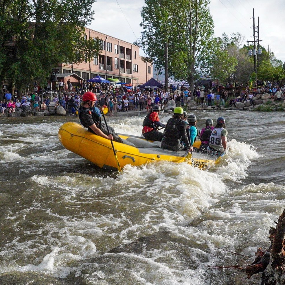 a group of people on a raft in a river
