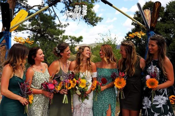 bridesmaids posing by the river