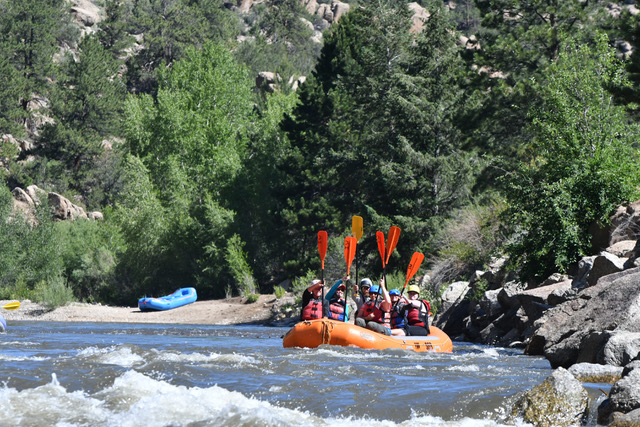 a group of people on a raft in a body of water