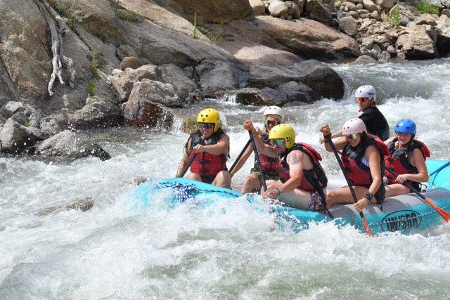 a group of people on a raft in a body of water