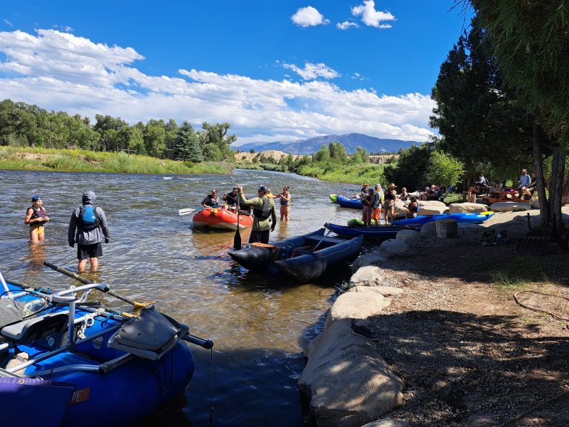 a group of people on a raft in a body of water