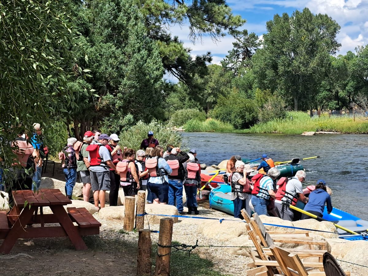 a group of people sitting at a picnic table
